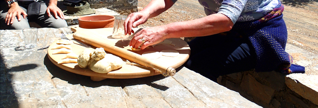 kneading traditional pies and bread on a table made of stone as part of a Cretan cooking workshop